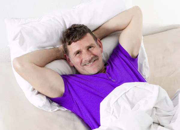 Man in bed smiling
