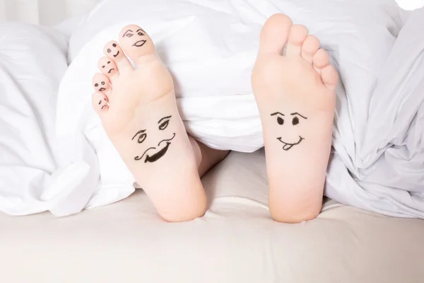 Bare feet with smiley faces