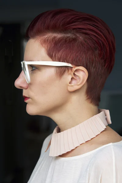 Side profile of a red-haired woman