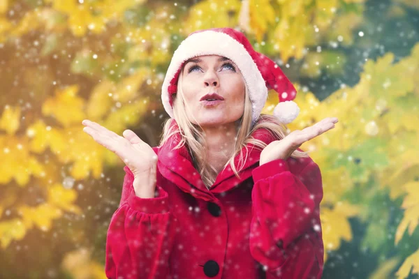 Woman with Santa hat enjoying first snow