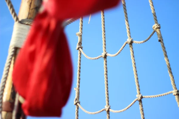 Sailboat rope ladder with scarlet sails