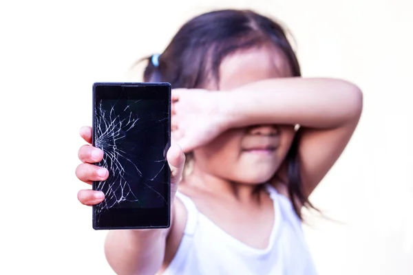 Child holding broken smartphone
