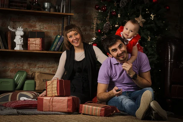 Happy family in front of christmas tree