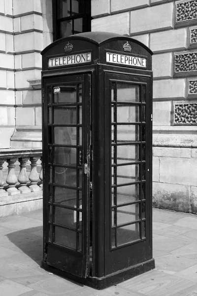 Traditional telephone booth in London, black and white photo