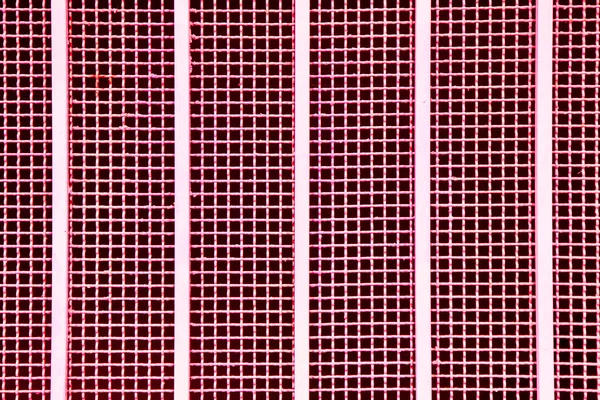 Close up red metal grille with vertical metal bars