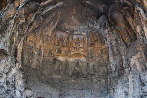 Buddha sculpture on cave wall in Longmen Grottoes