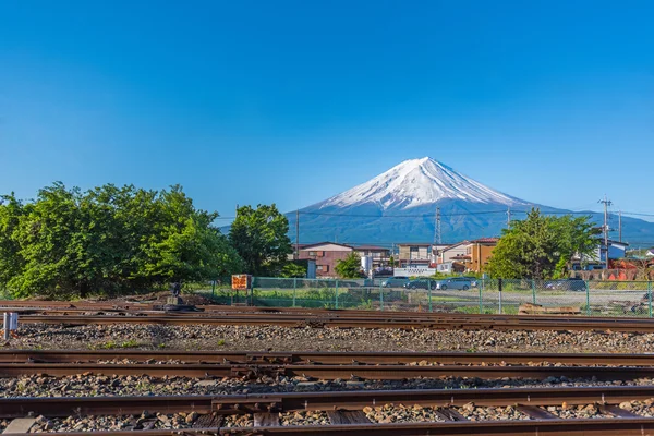 Kawaguchiko railroad tracks with Mount Fuji  in summer