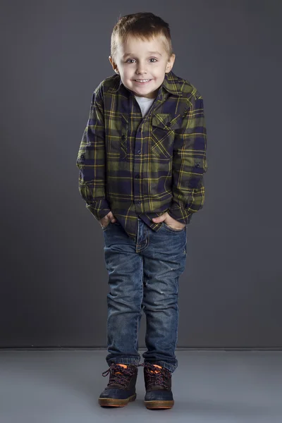 Funny child. fashionable little boy in  jeans, white shirt and plaid shirt. stylish kid  in shock and surprise. fashion children