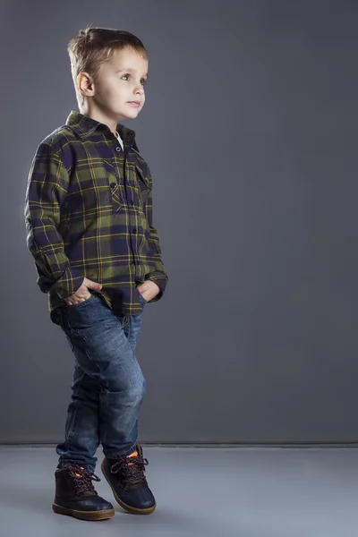 Funny child. fashionable little boy in  jeans, white shirt and plaid shirt. stylish kid  in shock and surprise. fashion children