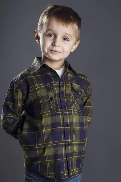 Funny child. fashionable little boy in  jeans, white shirt and plaid shirt. stylish kid  in shock and surprise. fashion children