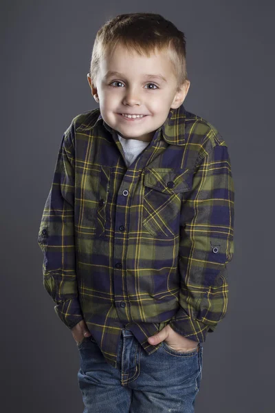 Funny child. fashionable little boy in  jeans, white shirt and plaid shirt. stylish kid  in shock and surprise. fashion children