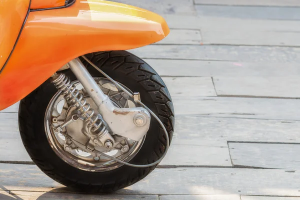 Front wheel motorbike on wood floor