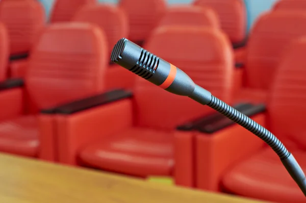 Microphone in front of empty chairs.