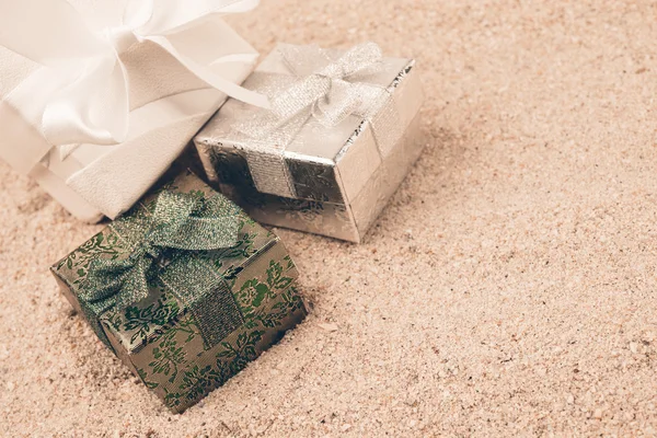 Gift boxes on sand
