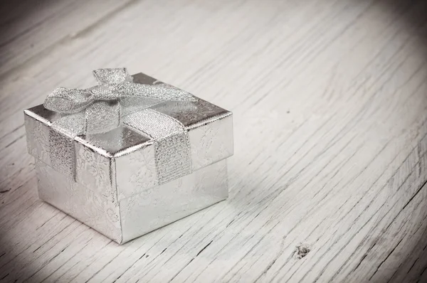 Silver gift box with a silver bow