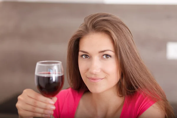 Portrait of a beautiful young woman with wine.