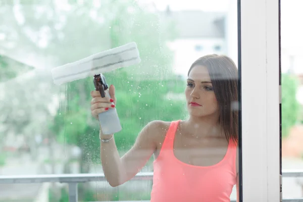 The girl washes the windows.