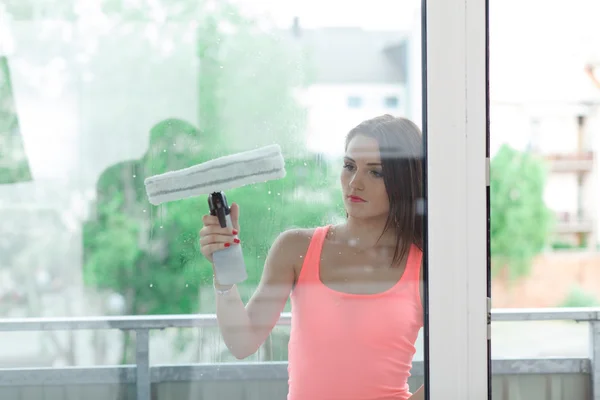 The girl washes the windows.