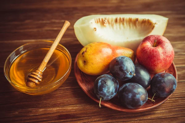 Fruits and honey on the table.