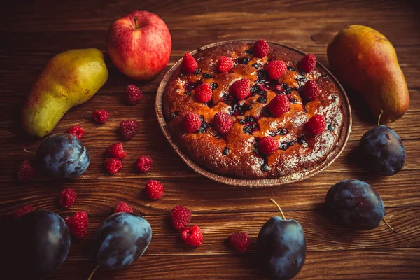 Fruit cake and fruit on the table.