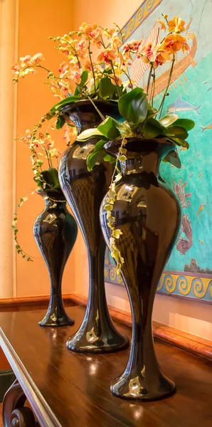 Composition of black vases with flowers