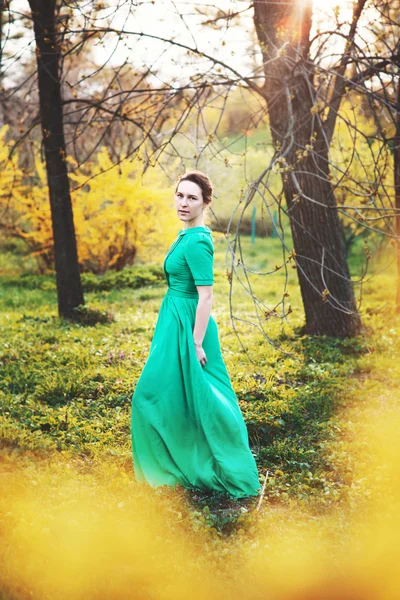 Beautiful woman in long dress in the forest