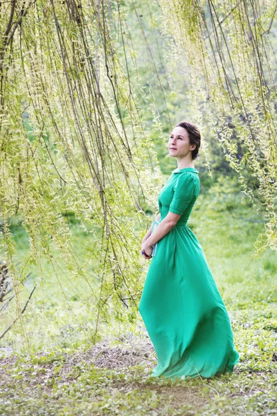 Beautiful woman in long dress in the forest