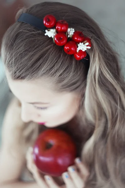 Portrait of beautiful woman with flowers in hair and blue eyes