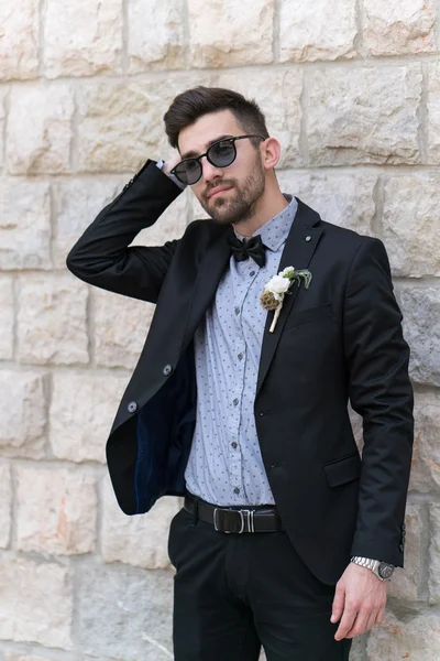 Sexy man in tuxedo posing
