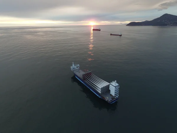 Aerial view of a cargo vessel loaded with rotor blades for wind turbines