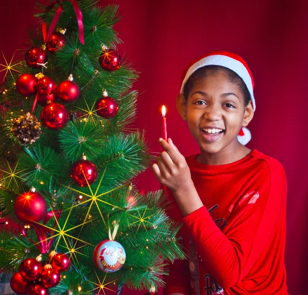 Black little girl decorate the Christmas tree