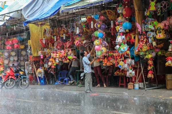 Ho Chi Minh City, Vietnam - August 17 2014 : Vietnamese lanterns shop in the rain in the mid-autumn festival at District 5 , Ho Chi Minh City ( Saigon ), Vietnam