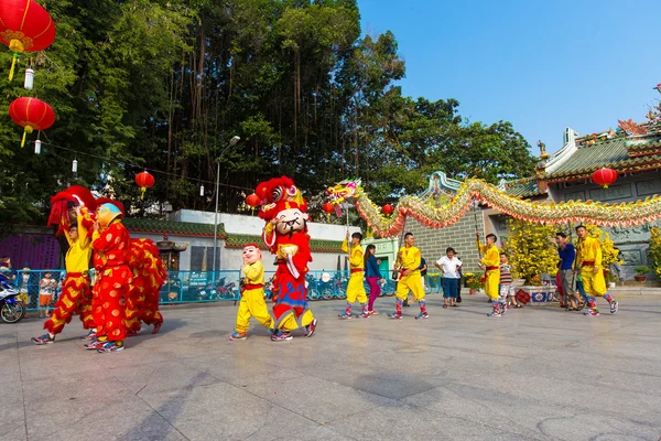 Ho Chi Minh City, Vietnam - February 18, 2015: A show of lion or dragon dance  at Pagoda, China Town, District 5, Cho Lon to praying heathty, safety and lucky during the lunar new year