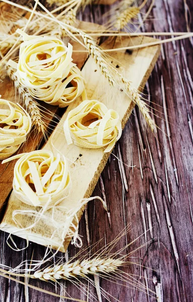 Uncooked pasta with flour on the table, selective focus