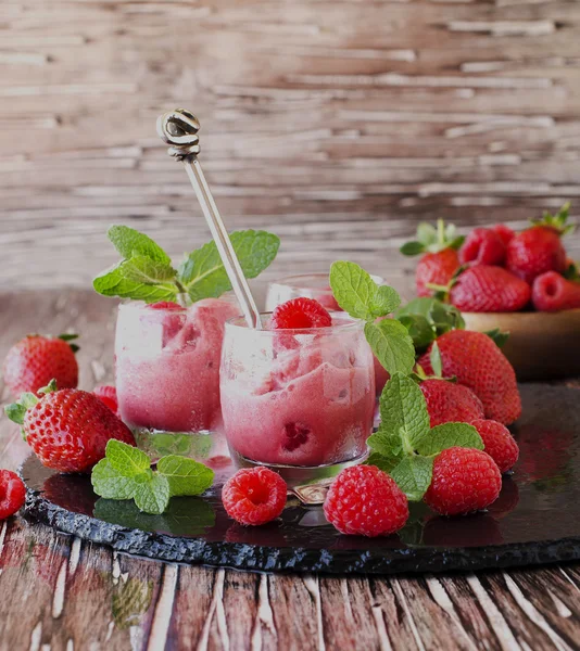 Frozen yogurt, sorbet with strawberries, raspberries and mint, selective focus