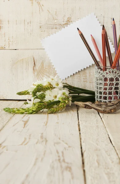 Pencils in the glass and flowers, selective focus