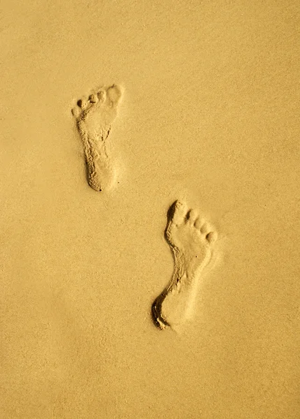 A pair of human footprints on the sand