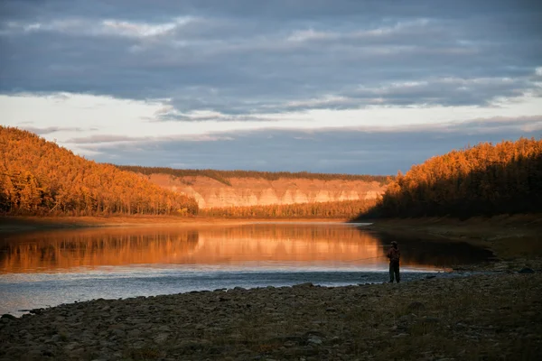 Evening fishing on the Siberian taiga rive