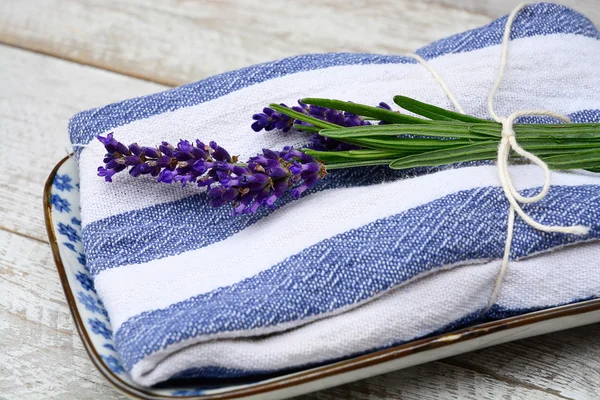 White grey old wooden shelves background with empty copy space and lavender flowers decoration on a blue white towel