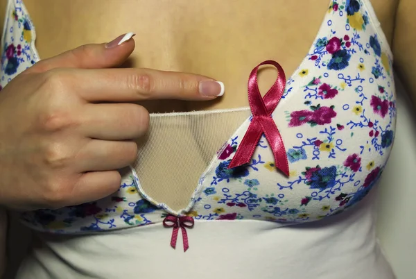 Woman pointing on pink ribbon
