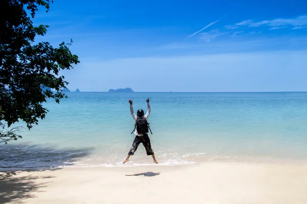 Man on beach and ocean view fog with his hands up relaxing enjoy