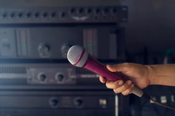 Microphone in woman hand on backstage of concert