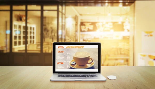 Laptop with menu coffee and tea on screen in coffee shop background