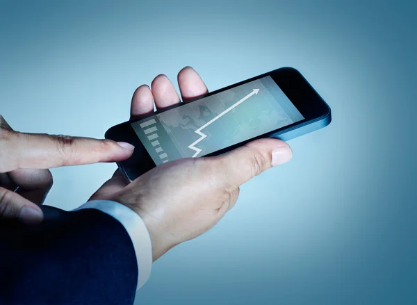 Businessman touching mobile phone graph and statistics rising on screen