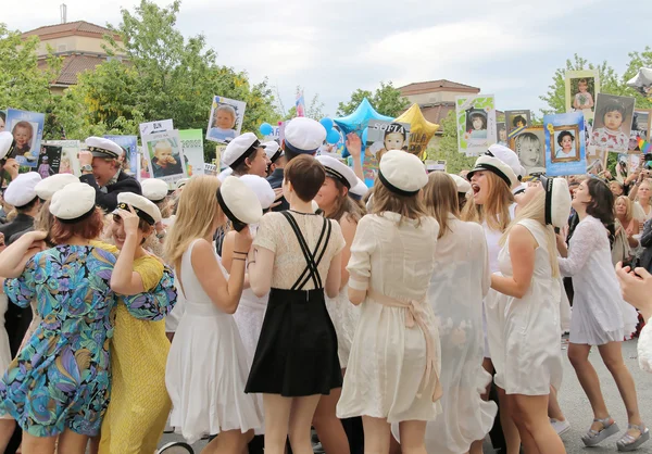 Happy teenagers dancing at the graduation