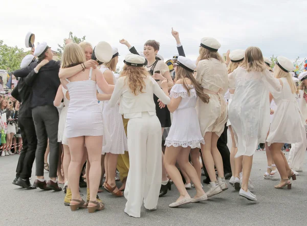 Happy teenagers dancing at the graduation