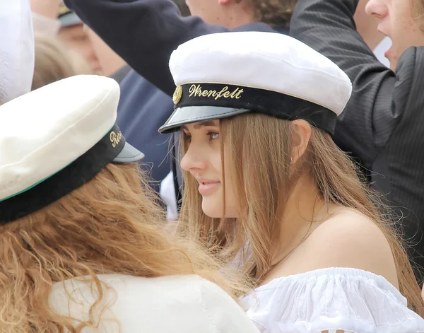 Happy teenage girls with wearing graduation cap celebrating the