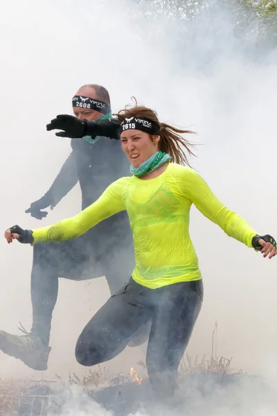 Woman and man running through fire and smoke