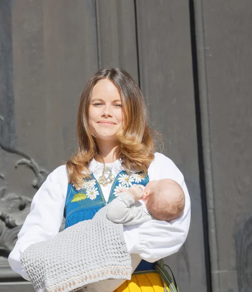 The smiling swedish princess Sofia Hellqvist holding baby Alexan