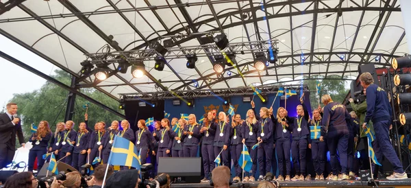Happy swedish female soccer team waving swedish flags